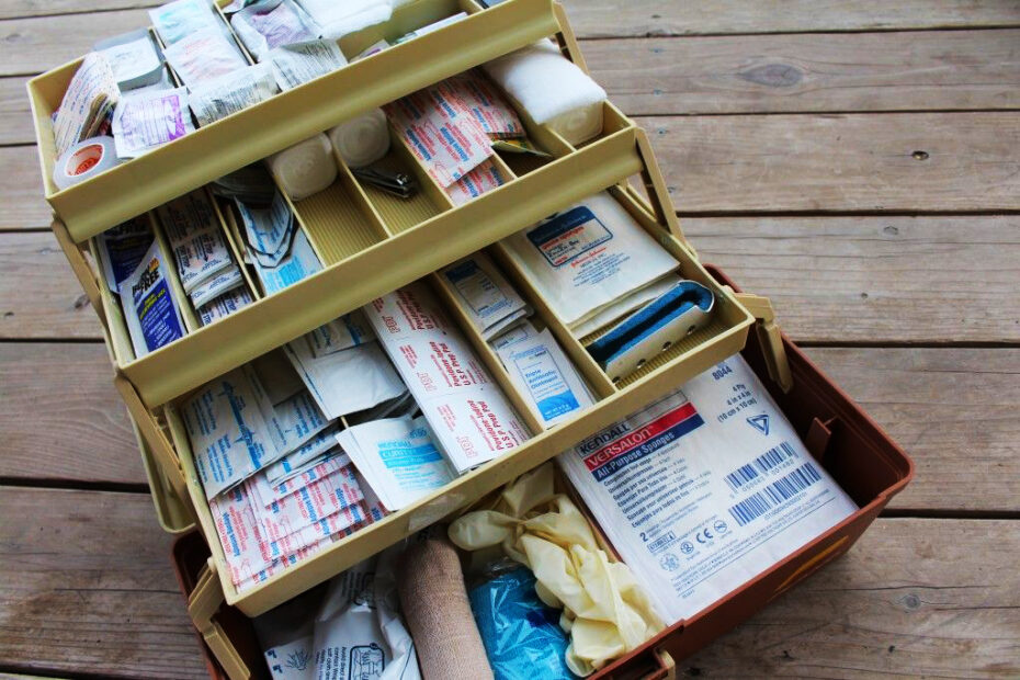 DIY first aid kit with various first aid items in a fishing tackle box