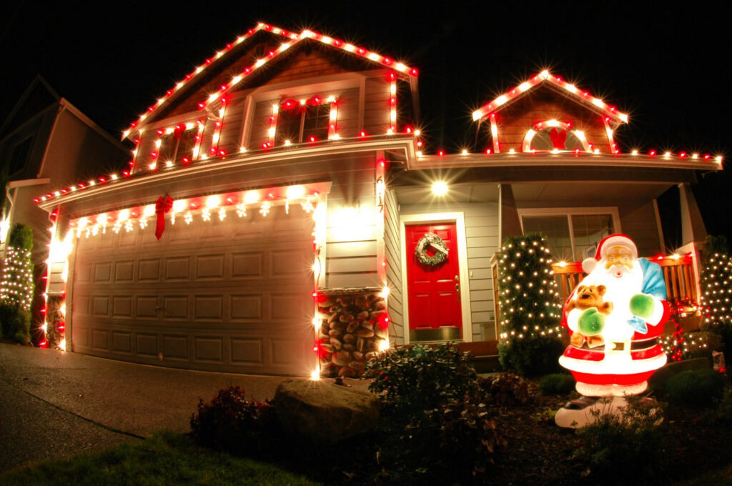 house with christmas lights Front of a home lit up with Christmas lights, a Santa Clause and a wreath on the door.