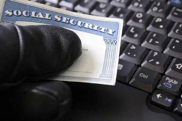 How Seniors Can Avoid Scams Social security card in a gloved hand-how seniors can avoid scams