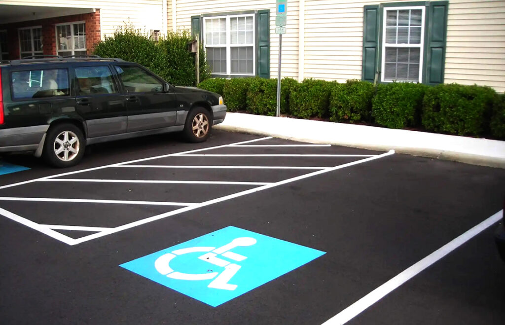 illegal disabled parking restrictions Car parked in disabled parking spot outside a building.