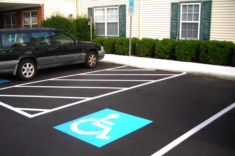 Car parked in disabled parking spot outside of a building.